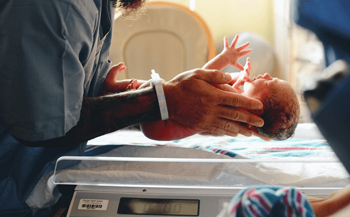 A premature infant receiving care in a Neonatal Intensive Care Unit (NICU), highlighting the critical environment where digital tools improve efficiency and outcomes.